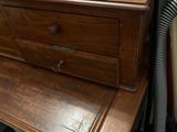 a wooden desk with a drawer on top of it