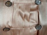 a close up of a dress with buttons on it
