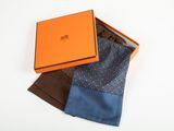 an orange box with three different colored ties in it on a white surface