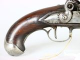 an old gun that is on display on a white surface
