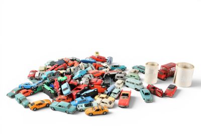 a pile of toy cars next to a roll of toilet paper