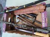 a lot of baseball bats in a box on the floor