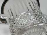 a glass pitcher that is sitting on a table