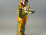 figurine of a man holding a bird in his hand