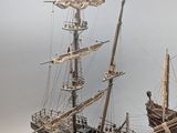 two model ships sitting side by side on a table