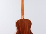 a wooden guitar hanging from a string on a white background