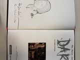 an open book with a drawing of a cat on it