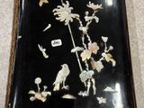 a picture of a black box with a bird and flowers on it