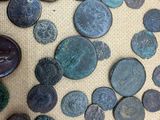 several different types of ancient coins are on a table
