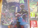 two nintendo wii games sitting on top of a table next to each other