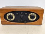 an old fashioned wooden radio sitting on top of a table