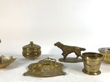 un grand nombre d'objets en laiton posés sur une table