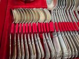 a red tray with silverware in it on a table
