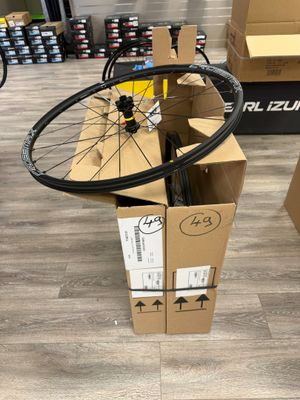 a bicycle wheel that is in a box on the floor