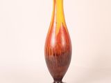 a vase that is sitting on a table with a white background