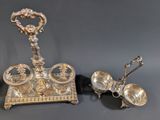two pieces of silverware are sitting on a black surface