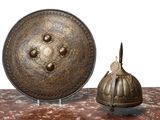 two metal objects sitting on a table with a white background