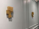 two pieces of cardboard on the wall next to each other