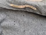 the back of a gray jacket with a zipper on it