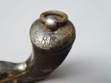 a metal pipe with a ring on it sitting on a table