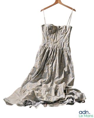 a dress hanging on a hanger on a white background