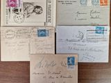 several old envelopes are sitting on top of a wooden table