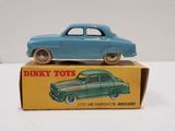 a blue toy car sitting on top of a box