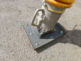 a yellow fire hydrant sitting on top of a metal pole