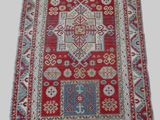 a red and blue rug with a pattern on it