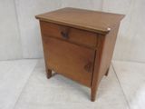 a small wooden table with a drawer on it