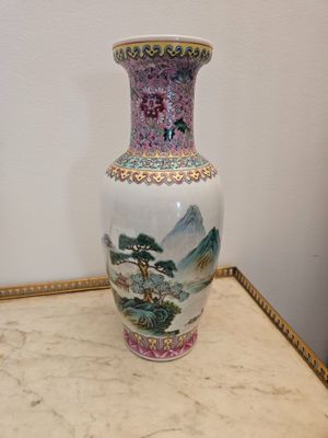 a vase that is sitting on a table with a picture on it