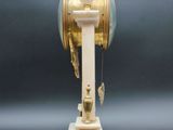 a clock that is sitting on a stand on a table