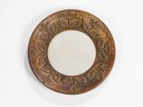 a mirror on the wall with a decorative design on it