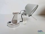 a lamp that is sitting on a table next to a cell phone