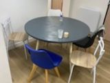 a table and chairs in a room with wood flooring