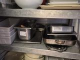 many dishes and pans on the shelves in the kitchen