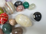 a lot of different colored stones on a white surface