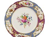 a close up of a plate with flowers on it on a white surface