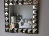 a mirror hanging on the wall in a living room