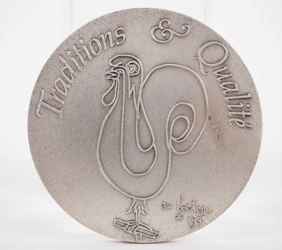 a silver coin with a rooster on it