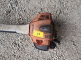 a chainsaw that is laying on the ground on the ground