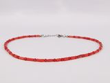 a red beaded necklace with a silver clasp