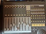 a sound board sitting on top of a table next to a laptop