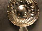 a silver object on a black surface next to a silver object