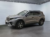 the silver suv is parked in a large room with white walls