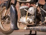 a motorcycle that is parked in front of a brick wall