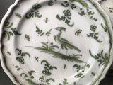 pair of green and white plates with birds and flowers on them