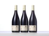 three bottles of wine sitting on top of a table