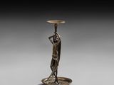 an image of a bronze statue of a woman holding a bowl
