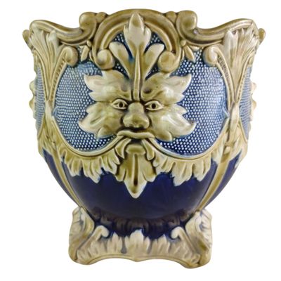 a blue and gold vase with a face on it